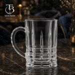 لیوان دسته دار از جنس بلور روی میز مشکی