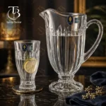 پارچ و لیوان شیشه ای از جنس بلور روی یک میز شیشه ای