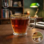 فنجان شیشه ای لب طلا از جنس بلور روی یک میز چوبی