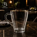لیوان شیشه ای لب طلا از جنس بلور روی یک میز